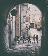 polignano,kids,passing,arch,faded.jpg